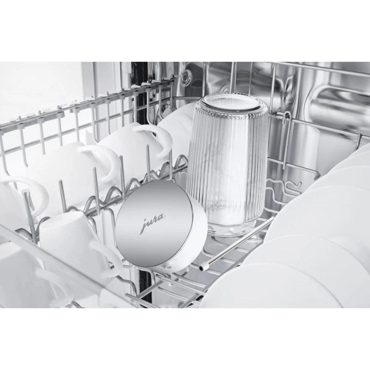 JURA Milk container EA (24313) inside a dishwasher among cups and plates, silver lid with 'jura' lettering and transparent glass
