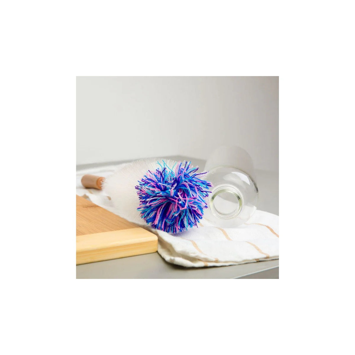 Aquafloow Bottle cleaning brush for carbonators showing white brush with wooden handle and blue‑purple tuft