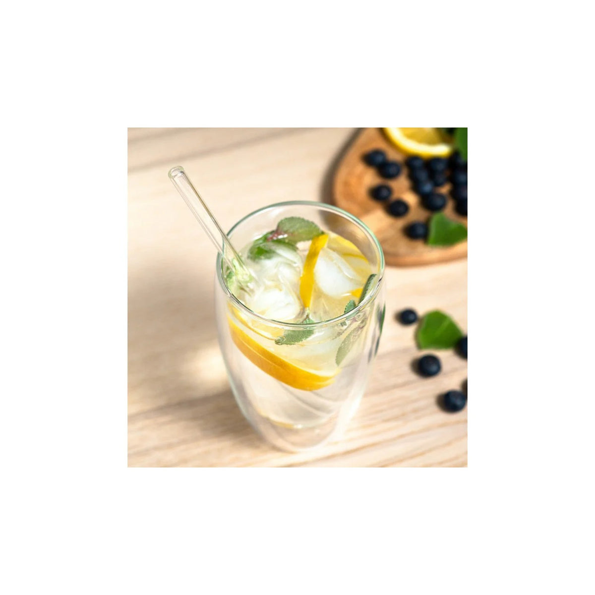 Sillar set of glass straws 8 pcs — glass straw in a drink with ice, lemon slices and mint leaves on a wooden surface