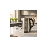 Aquafloow descaling tablets for coffee machines, kettles and irons (4 pcs) – pack on a kitchen counter beside a stainless kettle and...