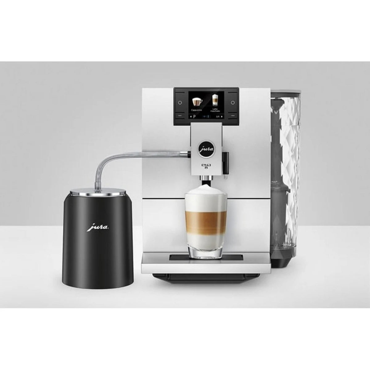 JURA Glacette milk container cooler black (24167) connected to a white coffee machine, black cooler with tubing and glass