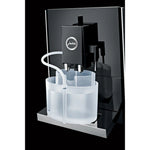 JURA Milk system cleaning container (24219) – transparent plastic container connected by tubing to a black milk outlet
